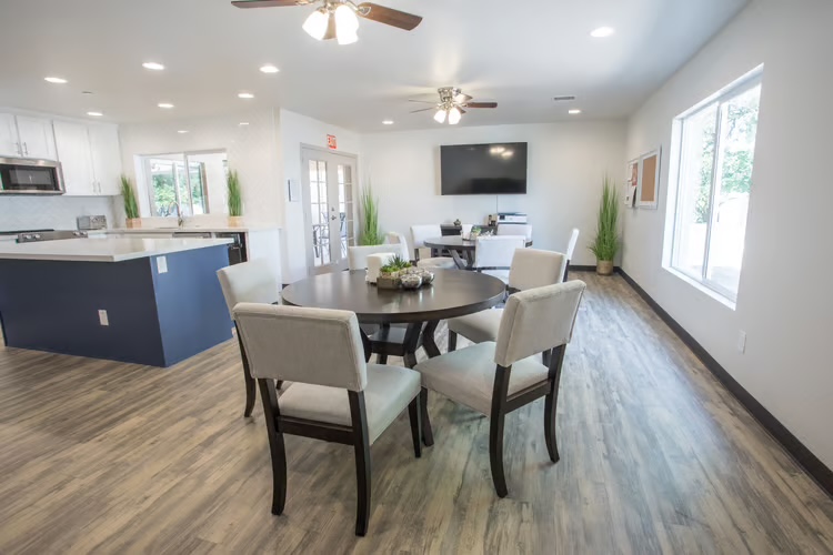 Open dining area and kitchen where residents share home-cooked meals at McCormick Ranch Assisted Living