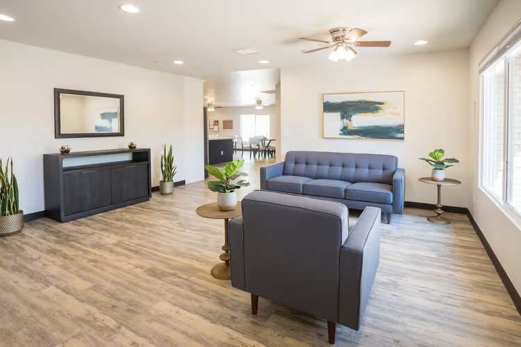 Living room with sofas and natural light at McCormick Ranch Assisted Living